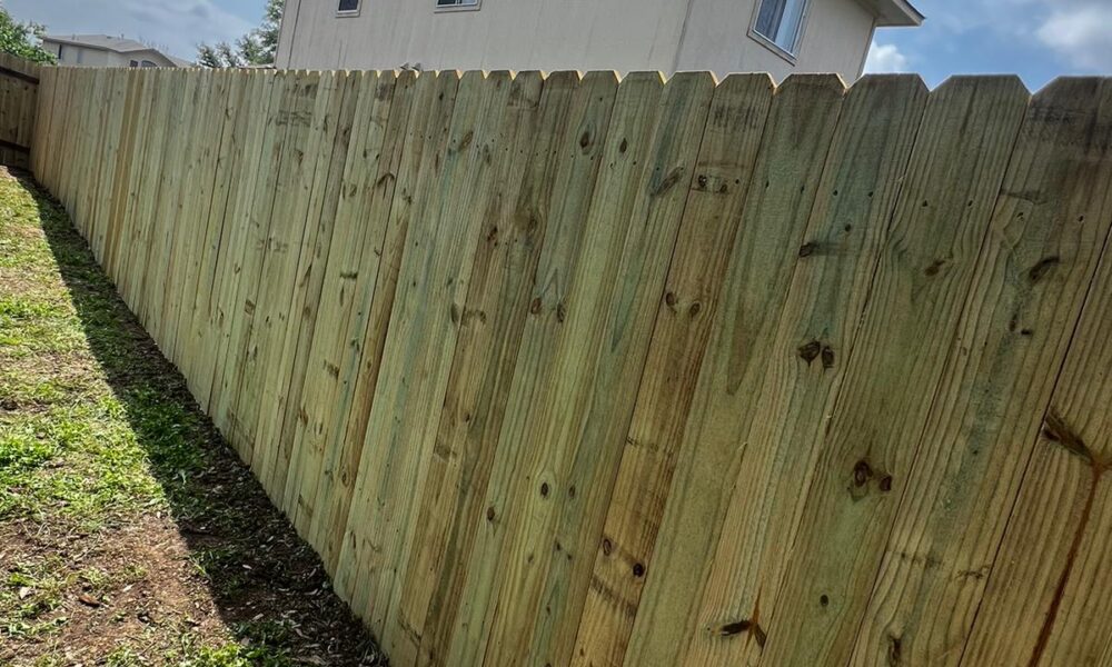 Newly completed wood privacy fence installation in a Hutto, TX residential backyard