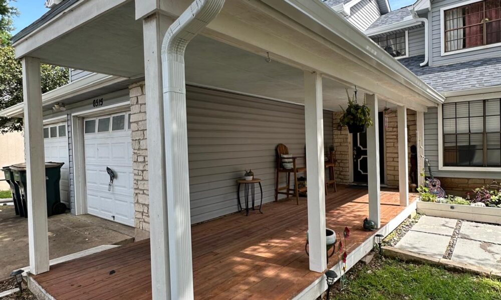 Close-up of newly installed downspout directing water away from the Hutto home's foundation